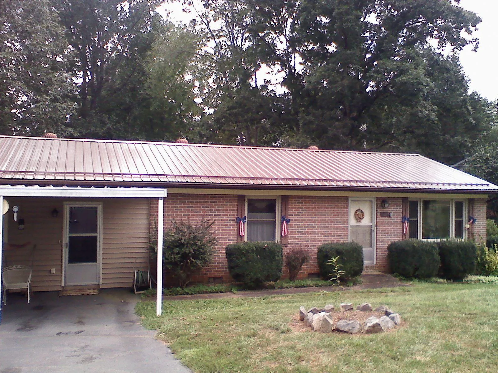 Bronze metal roof and carport on a brick ranch home — Roof Repair work by our crew in Wheaton