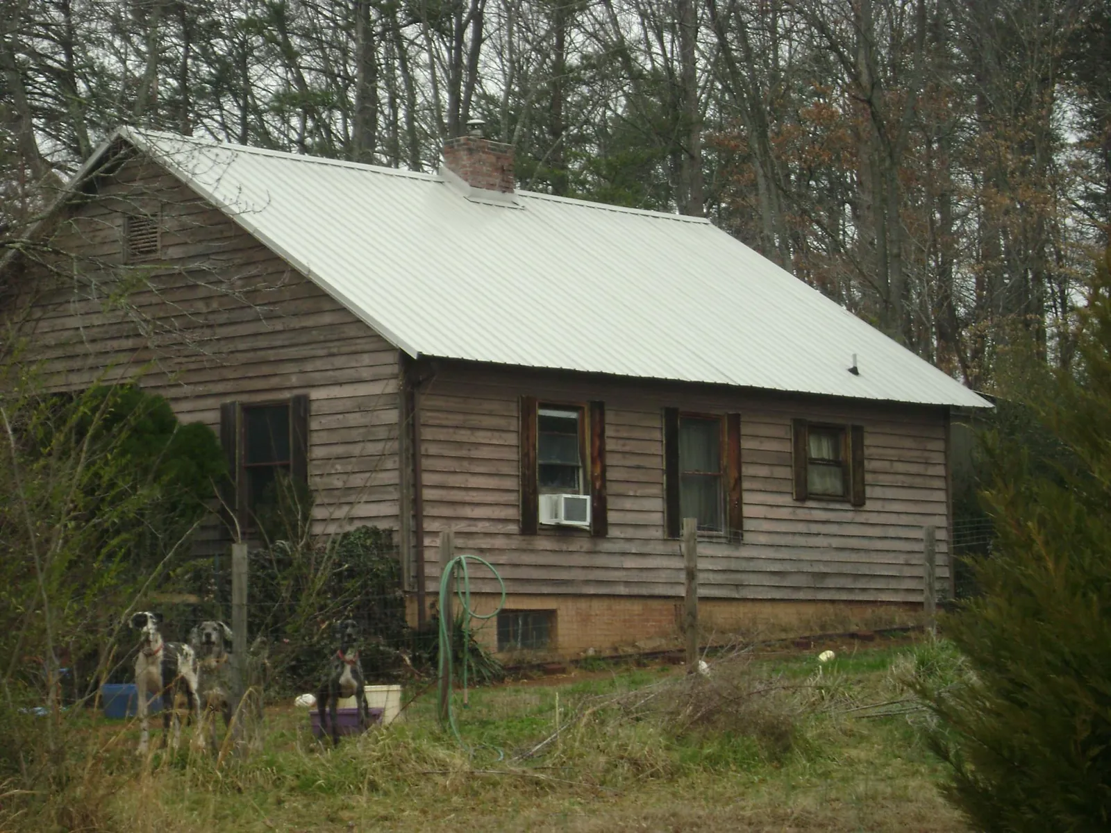 White metal roof on an old wood sided farmhouse, from a Metal Roof Installation job in Wheaton